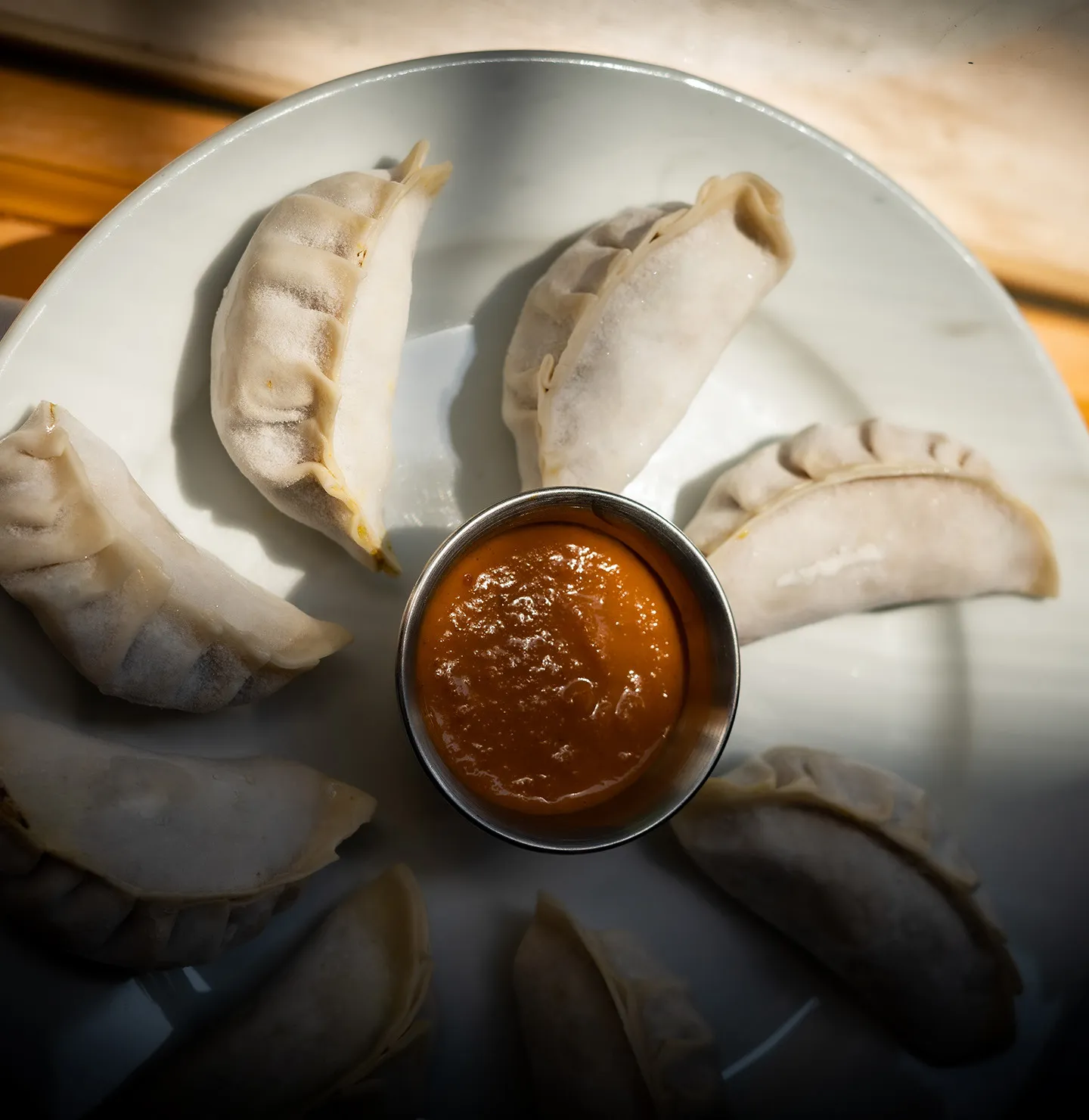 Hand-folded momos with house sauce